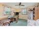 This bedroom features a large window, vintage floral curtains, and vintage furnishings at 807 Whitmore St, Anderson, IN 46012