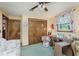 This bedroom features a large closet, vintage floral curtains, and vintage furnishings at 807 Whitmore St, Anderson, IN 46012