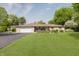 Charming brick ranch-style home featuring a spacious front yard and attached two-car garage at 807 Whitmore St, Anderson, IN 46012