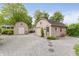 Exterior view of two detached garages with stone driveway and garden details at 807 Whitmore St, Anderson, IN 46012