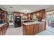 Well-lit kitchen with wood cabinets, appliances, and view into dining area at 807 Whitmore St, Anderson, IN 46012