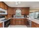 Functional kitchen featuring wooden cabinets, a light countertop, and stainless steel appliances at 807 Whitmore St, Anderson, IN 46012