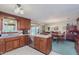 Traditional kitchen with wood cabinets, modern appliances, and adjacent dining area at 807 Whitmore St, Anderson, IN 46012