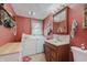 The laundry room features a stacked washer and dryer, sink, and storage; red-painted walls for a cozy feel at 807 Whitmore St, Anderson, IN 46012