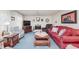 Inviting living room with blue carpet, fireplace, large TV and cozy furniture at 807 Whitmore St, Anderson, IN 46012