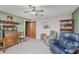 Cozy living room featuring a recliner, ceiling fan and unique display shelves and decorations at 807 Whitmore St, Anderson, IN 46012