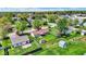 Aerial view of a home with a well-kept lawn, sheds, a patio, and mature trees in a suburban neighborhood at 8141 Rob Ln, Indianapolis, IN 46237