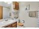 Cozy bathroom featuring a single sink vanity, toilet, and shower with neutral tones at 8141 Rob Ln, Indianapolis, IN 46237
