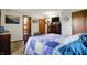 Bright bedroom with a patchwork quilt, ample storage, and multiple doorways at 8141 Rob Ln, Indianapolis, IN 46237