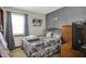 Comfortable bedroom with woodland themed bedding, natural light, and dresser at 8141 Rob Ln, Indianapolis, IN 46237