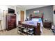 Bedroom features an ornate bed, dark wood dresser, and a shoe rack at 8141 Rob Ln, Indianapolis, IN 46237