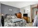 Comfortable bedroom with gray accent wall, wood furnishings, and ample natural light at 8141 Rob Ln, Indianapolis, IN 46237