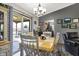 Bright dining room features a chandelier, sliding door access, and backyard views at 8141 Rob Ln, Indianapolis, IN 46237