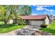 Charming single-story home features stone accents, mature trees, and a well-maintained lawn at 8141 Rob Ln, Indianapolis, IN 46237