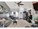 Inviting living room features plush seating, neutral carpet, ceiling fan and large window at 8141 Rob Ln, Indianapolis, IN 46237
