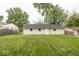 Backyard view of the home's back exterior and grassy lawn at 8145 Railroad Rd, Indianapolis, IN 46217