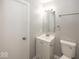 Bathroom with white vanity, mirror, towel rack and toilet at 8145 Railroad Rd, Indianapolis, IN 46217