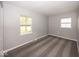 This is a bright bedroom featuring gray walls, carpet, and two windows that let in natural light at 8145 Railroad Rd, Indianapolis, IN 46217