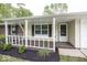 Welcoming front porch with fresh mulch landscaping, painted railing, and decorative shutters offers curb appeal at 8145 Railroad Rd, Indianapolis, IN 46217