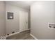 Hallway with gray walls and wood-look flooring and white door at 8145 Railroad Rd, Indianapolis, IN 46217