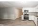 Contemporary kitchen with stainless steel appliances, granite countertops, and updated white cabinetry at 8145 Railroad Rd, Indianapolis, IN 46217