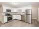 Modern kitchen with stainless steel appliances, granite countertops, and sleek white cabinets offers ample storage at 8145 Railroad Rd, Indianapolis, IN 46217