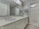 Bathroom with double sinks, white cabinets, and a large mirror at 820 Scotch Pine Dr, Greenwood, IN 46143
