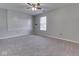 Spacious bedroom with neutral carpet, a ceiling fan, and a large window, providing ample natural light at 820 Scotch Pine Dr, Greenwood, IN 46143