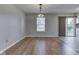 Dining room features hardwood floors, a large window, and a sliding door to the patio at 820 Scotch Pine Dr, Greenwood, IN 46143