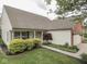 Attractive single-story home with a cozy front porch, tidy landscaping, and a brick-accented garage at 820 Scotch Pine Dr, Greenwood, IN 46143