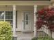 Cozy front porch featuring decorative columns, a storm door, and landscaping at 820 Scotch Pine Dr, Greenwood, IN 46143