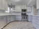 Well-lit kitchen with stainless steel appliances, sleek cabinetry, and stylish flooring at 820 Scotch Pine Dr, Greenwood, IN 46143
