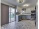 Bright kitchen with stainless steel appliances, gray cabinets, and sliding door to backyard at 820 Scotch Pine Dr, Greenwood, IN 46143