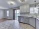 Bright kitchen with updated appliances, view of the backyard, and brick flooring at 820 Scotch Pine Dr, Greenwood, IN 46143