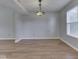 Spacious living room with a large window and hardwood floors under a decorative hanging light fixture at 820 Scotch Pine Dr, Greenwood, IN 46143