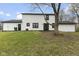 Expansive backyard featuring a well-maintained lawn, and the rear of the home shows the siding and some doors and windows at 8315 N Payne Rd, Indianapolis, IN 46268