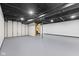 Open basement with gray painted floor and a black painted ceiling and wooden support beam at 8315 N Payne Rd, Indianapolis, IN 46268