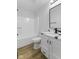 Bathroom with shower/tub combo, single sink vanity with storage and modern fixtures at 8315 N Payne Rd, Indianapolis, IN 46268