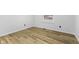 Bedroom featuring hardwood floors, white walls, and a bright window with a view of the outdoors at 8315 N Payne Rd, Indianapolis, IN 46268