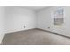 Bright bedroom featuring neutral carpet and a window for natural light at 8315 N Payne Rd, Indianapolis, IN 46268