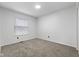 Bright bedroom with carpeted floor, white walls, and a single window at 8315 N Payne Rd, Indianapolis, IN 46268
