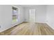 A bright bedroom features hardwood floors, a large window, and white walls at 8315 N Payne Rd, Indianapolis, IN 46268