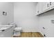 Laundry room with white cabinets, modern sink, toilet, and a washer/dryer hookup at 8315 N Payne Rd, Indianapolis, IN 46268
