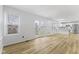 Bright living room showing hardwood floors, a window and french doors, with kitchen in view at 8315 N Payne Rd, Indianapolis, IN 46268