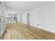 Spacious living room featuring light hardwood floors and access to the kitchen at 8315 N Payne Rd, Indianapolis, IN 46268