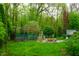 Backyard with fire pit, stump seats, and a trellis garden, creating a serene outdoor living space at 8727 Redditch Dr, Avon, IN 46123