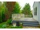 Backyard view showcasing a spacious deck, mature trees, and lush landscaping, offering a private outdoor retreat at 8727 Redditch Dr, Avon, IN 46123