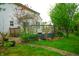 Lovely backyard showing the patio and landscaping of the home, with a large wooden fence surrounding the raised patio at 8727 Redditch Dr, Avon, IN 46123