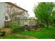 Lovely backyard showing the patio and landscaping of the home, with a large wooden fence surrounding the raised patio at 8727 Redditch Dr, Avon, IN 46123
