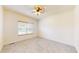 Bright bedroom featuring neutral carpet, ceiling fan and a window dressed with white blinds at 8727 Redditch Dr, Avon, IN 46123
